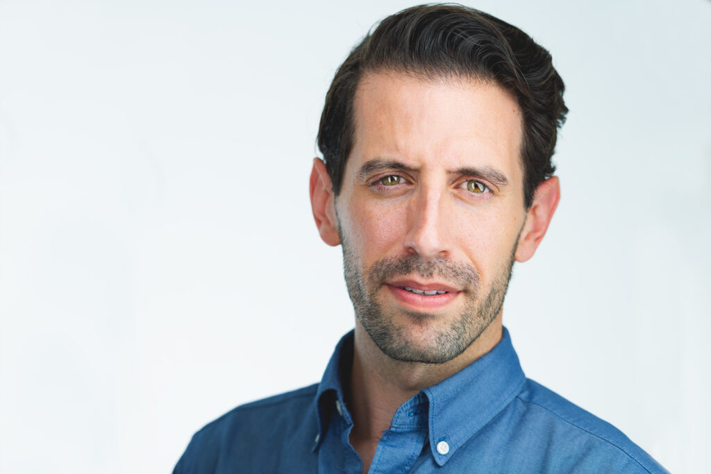 White male in business casual attire with a white background, headshot, sharp and professional look, featuring calming eyes. NYC Photographer