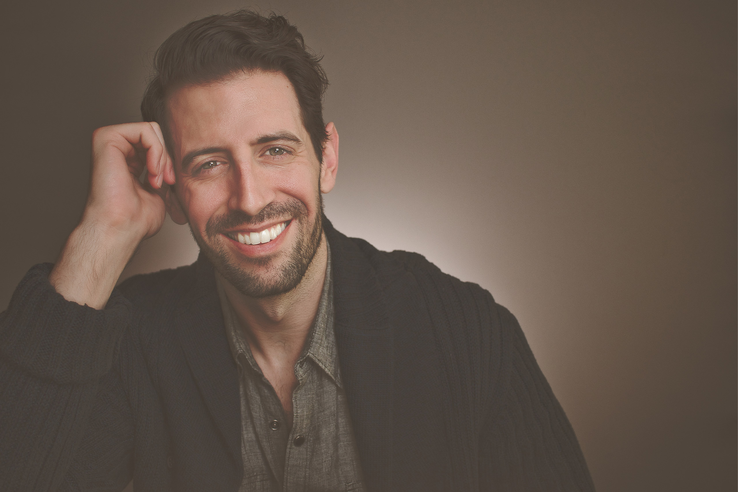 Lifestyle shot of a smiling gentleman, warm and approachable.