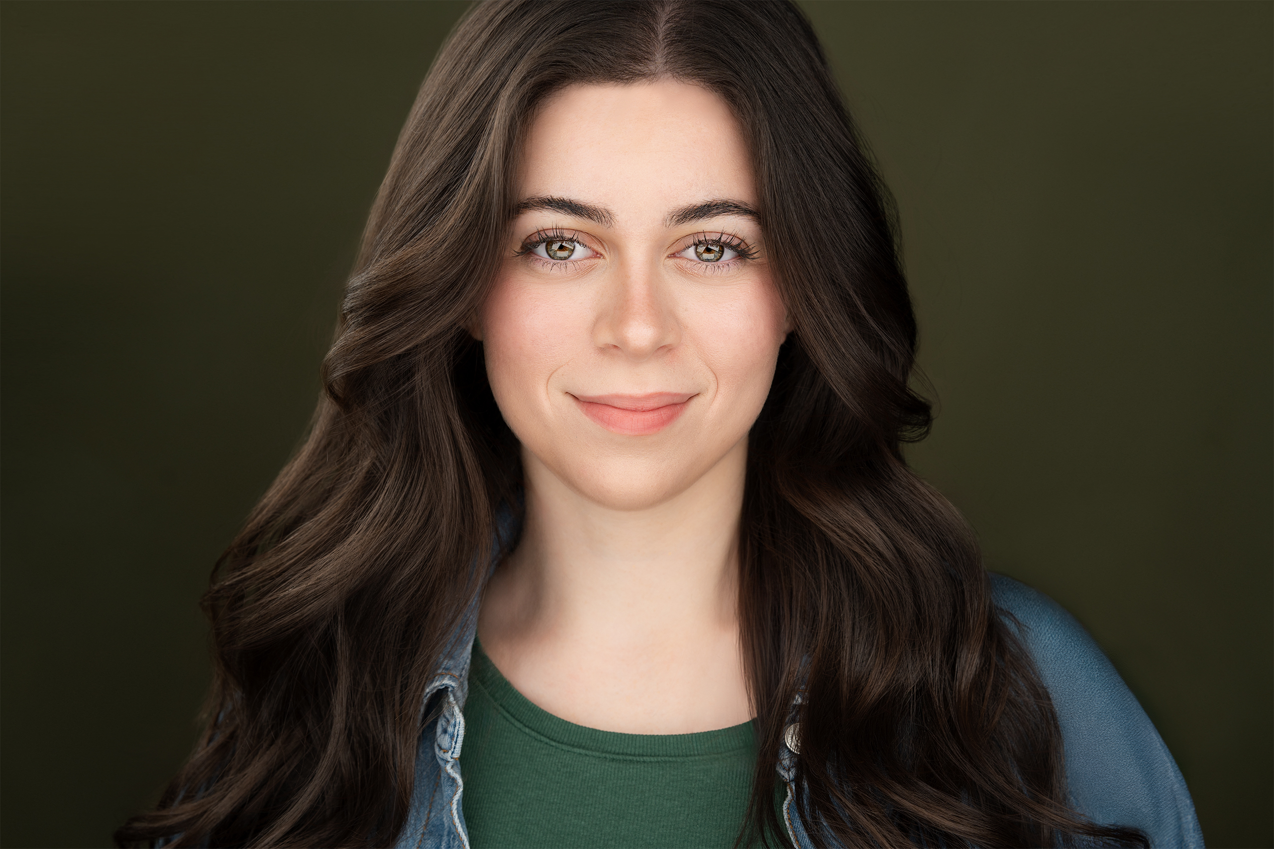 NYC Headshot Photographer capturing a brunette actress with olive green background.