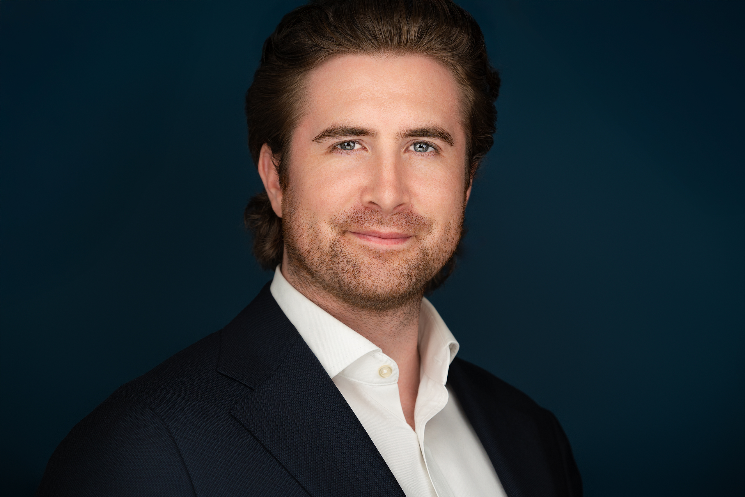 Man, slight smile, corporate headshot, nyc