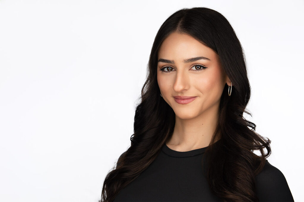 Black haired professional, with olive skin, approachable smile, small hoop earrings, white background, business, headshot photographer, nyc, headshot