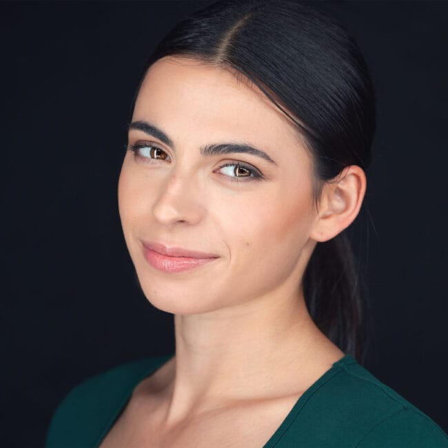 Actor headshot of Amy Puchini against a dark blue background