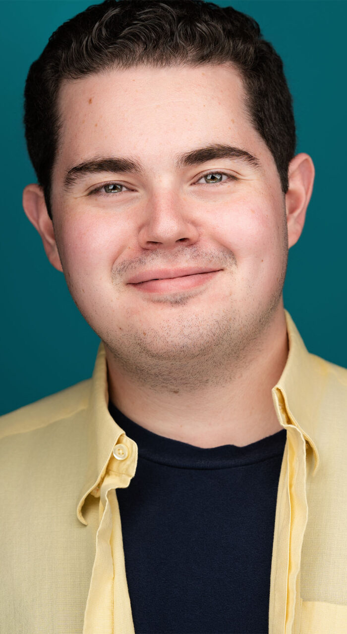 Actor headshot of Brandon Semmel against a teal background