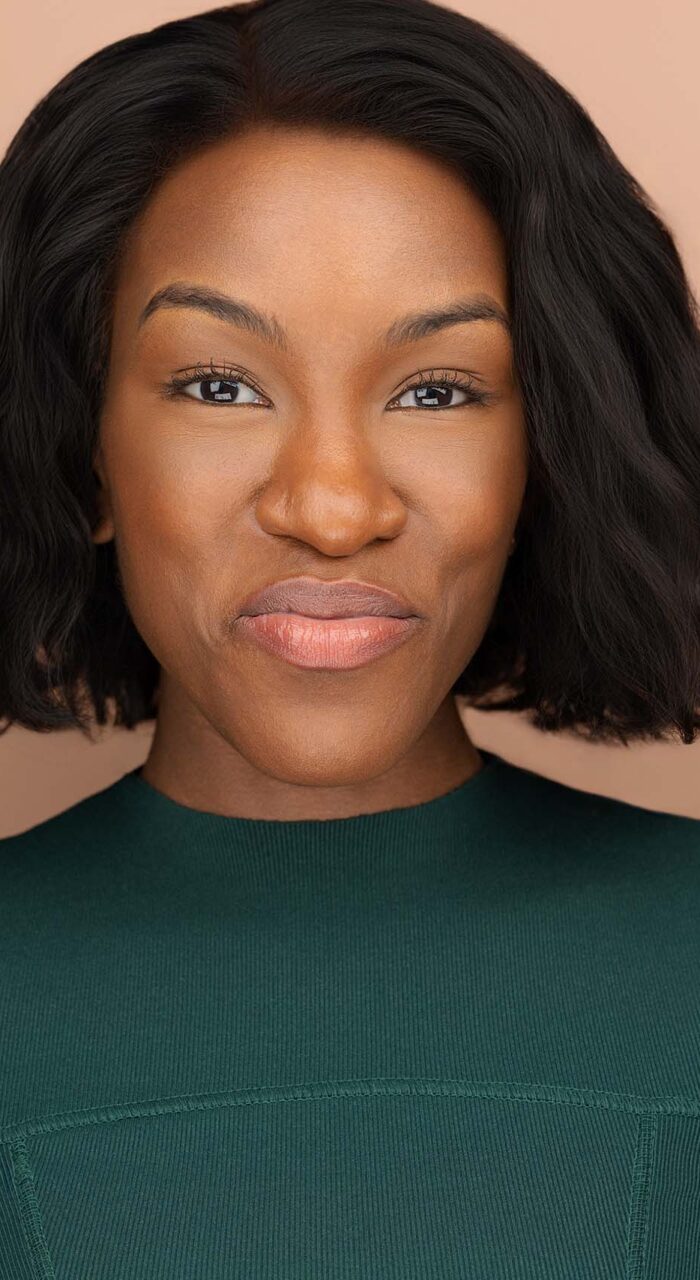 Actor headshot of Lucia Williams against a peach background